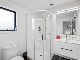 A bathroom with a shower and sink at Hosking Haven - Cromwell Holiday Home in Cromwell
