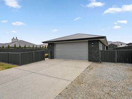 An exterior view of a house with a garage and driveway at Hosking Haven - Cromwell Holiday Home in Cromwell