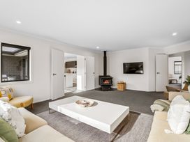 A living room with a coffee table and fireplace at Hosking Haven - Cromwell