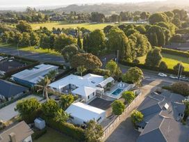 An aerial view of a house with a pool and garden at Poolside on Moffat in Tauranga
