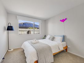 A bedroom with a bed and lamp at Sunny Deck Haven - Richmond