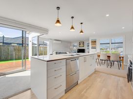 A kitchen with an island and a dining area at Sunny Deck Haven - Nelson Holiday Home, Richmond