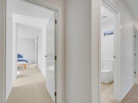 A hallway with a bedroom and bathroom at Sunny Deck Haven - Nelson Holiday Home in Richmond