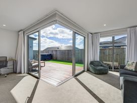 A living room with a sliding door and a desk at Sunny Deck Haven - Richmond