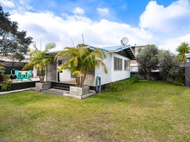 A house with a garden and patio at Slice of paradise - Whangamata Holiday Home in Whangamata