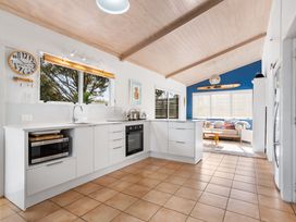 A kitchen with microwave and oven at Slice of paradise - Whangamata Holiday Home Whangamata