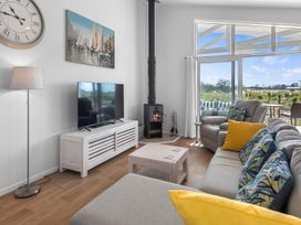 A living room with a television and seating area at Pu Corner - Waipu Holiday Home in Waipu