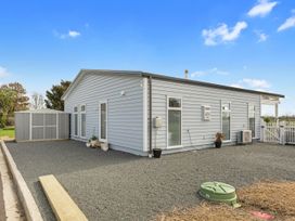 An outdoor area of a house with a shed at Pu Corner - Waipu Holiday Home in Waipu
