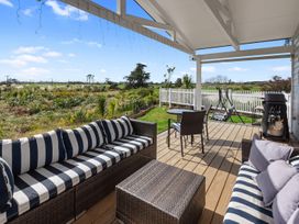An outdoor patio with a sofa and table at Pu Corner - Waipu Holiday Home, Waipu