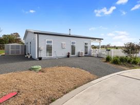 A house with a gravel area and small shed at Pu Corner - Waipu Holiday Home Waipu