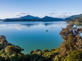 A scenic view of water and mountains at The Bay house - Moetapu Holiday Home in Moetapu Bay