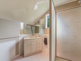 A bathroom with a vanity and shower at The Bay house - Moetapu Holiday Home Moetapu Bay