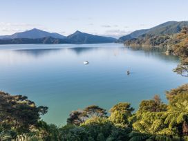 A view of a waterbody and mountains at The Bay house - Moetapu Holiday Home, Moetapu Bay