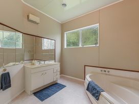 A bathroom with a bathtub and sink at The Bay house - Moetapu Holiday Home