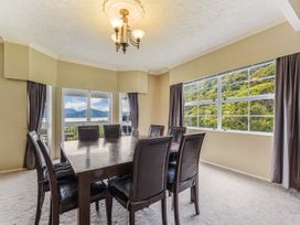 A dining room with a table and chairs at The Bay house - Moetapu Holiday Home