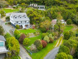 An outdoor view of a house and garden at The Bay house - Moetapu Holiday Home, Moetapu Bay