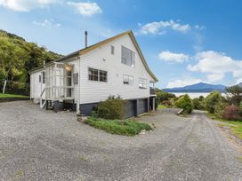 A house with a driveway and garden at The Bay house - Moetapu Holiday Home Moetapu Bay