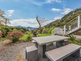 An outdoor area with a table and bench at The Bay house - Moetapu Holiday Home, Moetapu Bay