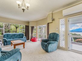 A living room with sofas and a coffee table at The Bay house - Moetapu Holiday Home in Moetapu Bay