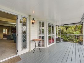 A deck with a table and chair at The Bay house - Moetapu Holiday Home Moetapu Bay