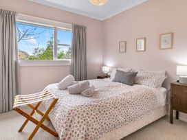 A bedroom with a bed and bedside tables at Garden Grove - Kapiti Coast Holiday Home Kapiti Coast