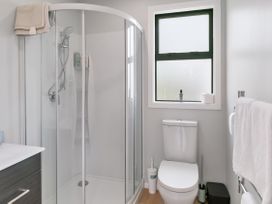 A bathroom with a shower, toilet, and sink at Garden Grove - Kapiti Coast Holiday Home, Kapiti Coast