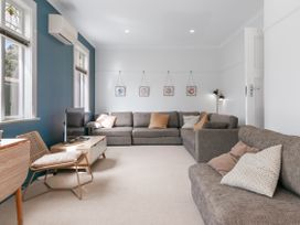 A living room with a sofa and coffee table at Garden Grove - Kapiti Coast Holiday Home in Kapiti Coast
