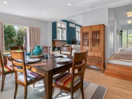 A dining room with a table and chairs at Garden Grove - Kapiti Coast Holiday Home Kapiti Coast
