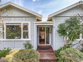 An entrance to a house with plants and a pathway at Garden Grove - Kapiti Coast Holiday Home Kapiti Coast