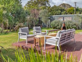 A garden with seating and a table at Garden Grove - Kapiti Coast Holiday Home, Kapiti Coast