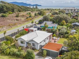 An outdoor view of a house surrounded by greenery at Garden Grove - Kapiti Coast Holiday Home Kapiti Coast