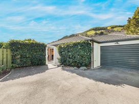 An outdoor view showing a house entrance and garage at Magnolia Cottage - Nelson Holiday Homes Levin