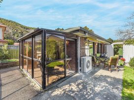 An outdoor space with a patio, table, and chairs at Magnolia Cottage - Levin
