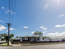 A house with trees and power lines in Home away from Home - Levin Holiday Home in Foxton