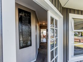 A hallway with a door and artwork at Home away from Home - Levin Holiday Home Foxton