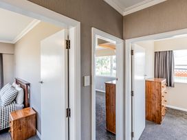 A bedroom with a bed and dresser at Home away from Home - Levin Holiday Home, Foxton