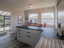 A kitchen with a dining table and chairs at Home away from Home - Levin Holiday Home Foxton