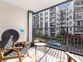 A balcony with outdoor furniture at Westlight Apartment - Henderson Holiday Home, Auckland