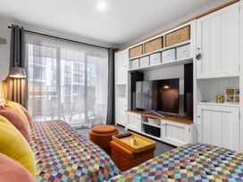 A living room with a television and sofa at Westlight Apartment - Henderson Holiday Home, Auckland