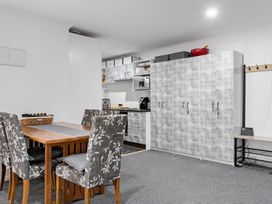 A kitchen with a dining table and chairs at Westlight Apartment - Henderson Holiday Home in Auckland