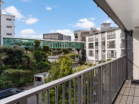 A view from a balcony showing buildings and a glass walkway at Westlight Apartment - Henderson Holiday Home in Auckland