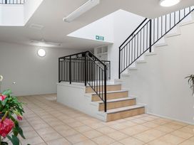 A stairwell with a staircase and plants at Westlight Apartment - Henderson Holiday Home, Auckland