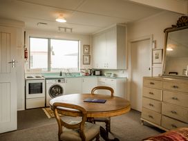 A kitchen with a table and chairs at Southern Base - Te Anau Holiday Home in Te Anau