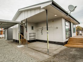 An outdoor area featuring a door and stairs at Southern Base - Te Anau Holiday Home in Te Anau