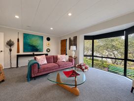A living room with a sofa and coffee table at Gallery Grove - New Plymouth Holiday Home in New Plymouth