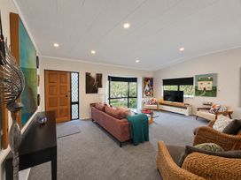 A living room with a sofa and television at Gallery Grove - New Plymouth Holiday Home in New Plymouth