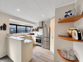 A kitchen with a sink and stove at Gallery Grove - New Plymouth Holiday Home, New Plymouth