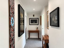 A hallway with a table and artwork at Gallery Grove - New Plymouth Holiday Home in New Plymouth