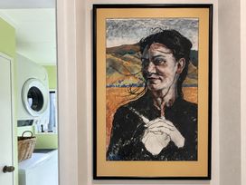 A portrait on the wall in a laundry room at Gallery Grove - New Plymouth Holiday Home New Plymouth