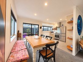A dining room with a table and chairs at Gallery Grove - New Plymouth Holiday Home, New Plymouth